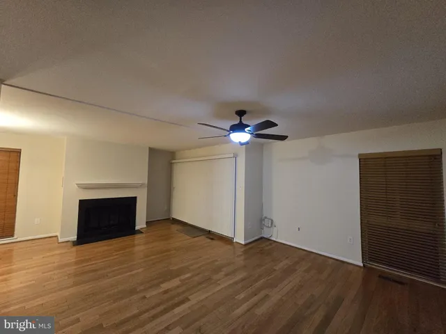 a bathroom with a granite countertop toilet sink and mirror