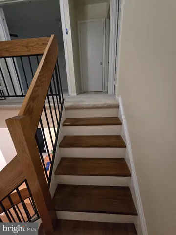 a bathroom with a granite countertop toilet sink and mirror