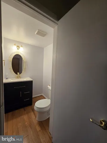 a bathroom with a toilet a sink and mirror