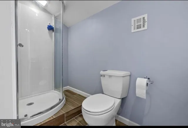 a white toilet sitting next to a bath tub shower