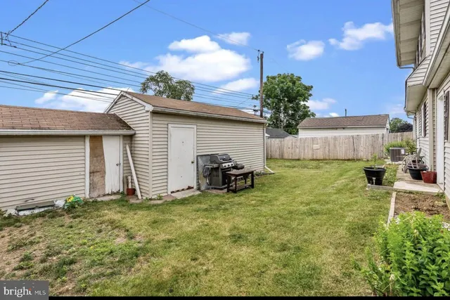 a view of a chairs and table in backyard