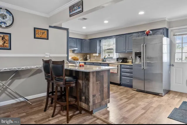 a kitchen with kitchen island a dining table and appliances