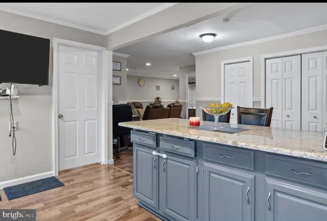 a spacious bathroom with a granite countertop sink a mirror and shower