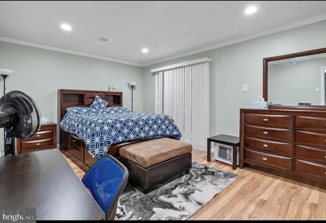 a bedroom with a bed and a dresser