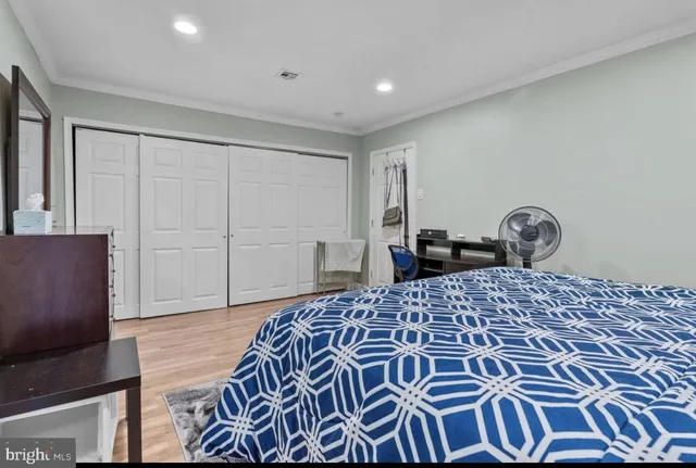 a bedroom with a bed and a dresser