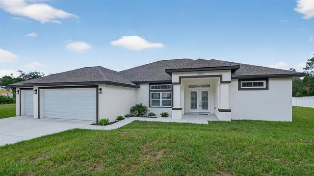 a front view of house with yard and green space