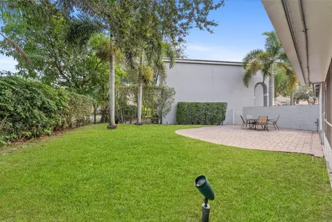 a view of a backyard with a garden and entertaining space
