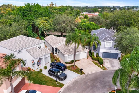 an aerial view of a house with garden space and street view