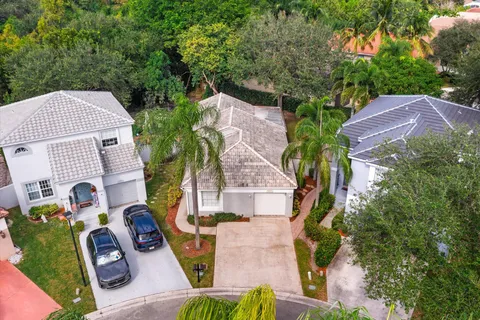 an aerial view of a house with garden space and street view