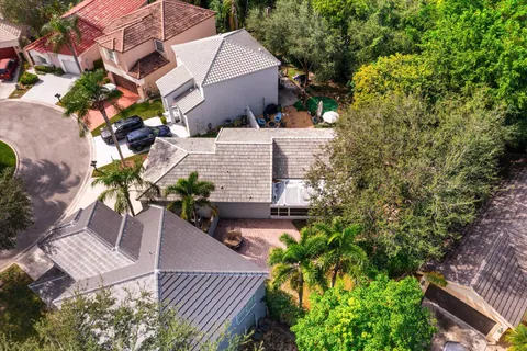 an aerial view of a house with garden space and lake view