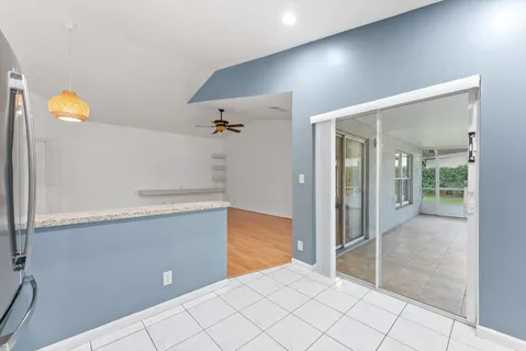 a large white kitchen with stainless steel appliances