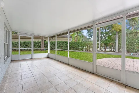 a view of an empty room with a yard and balcony