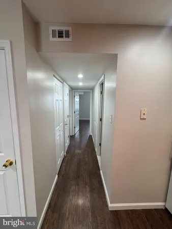 a view of hallway with wooden floor