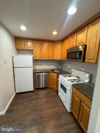 a kitchen with a stove a sink and a refrigerator