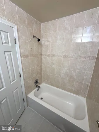 a bathroom with a bathtub and shower