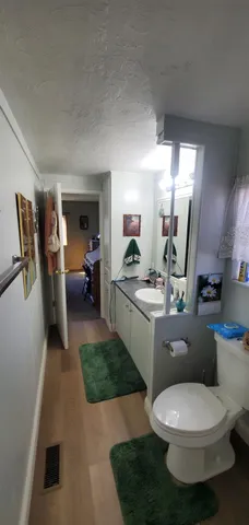 a bathroom with a toilet sink and mirror