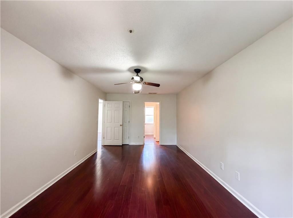 3753 Soapstone Road Decatur, GA 30034 - Photo 15 of 26 an empty room with wooden floor and chandelier fan