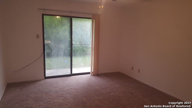 320 Station Street, Unit 101 Converse, TX 78109 - Photo 10 of 14 a view of an empty room with sliding glass door