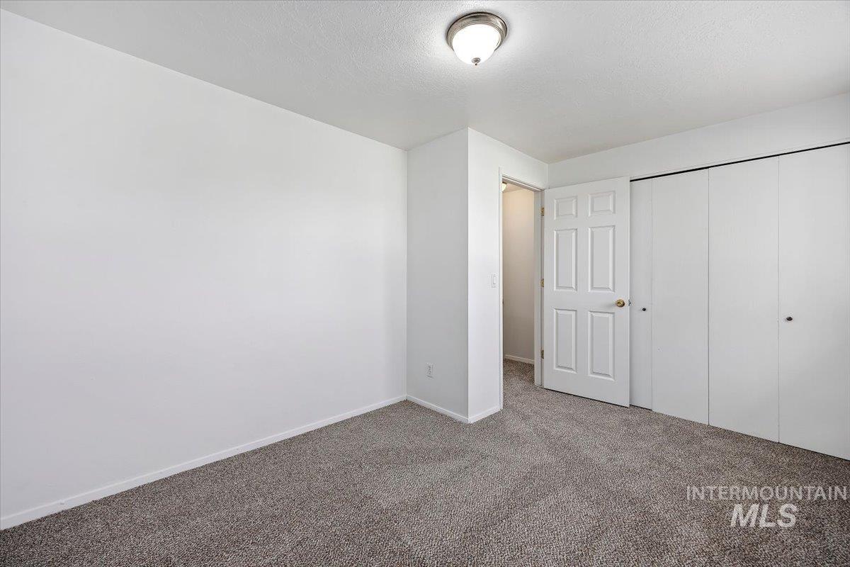 259 Pheasant Road, Unit 83 Twin Falls, ID 83301 - Photo 15 of 26 Neutral tone wall paint, textured ceiling, flush mount ceiling light, carpet flooring, paneled interior door