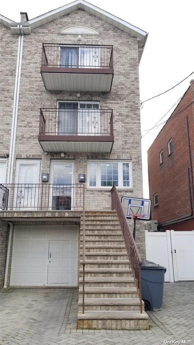 a front view of a house with barbeque grill and stairs