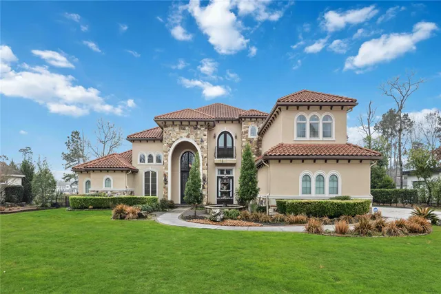a front view of a house with a garden and plants