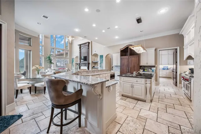 a kitchen with granite countertop a sink stainless steel appliances a cabinets and a window