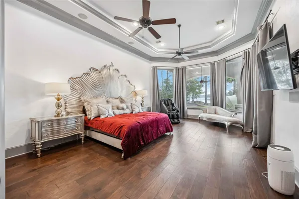 a bedroom with a bed and a flat tv screen