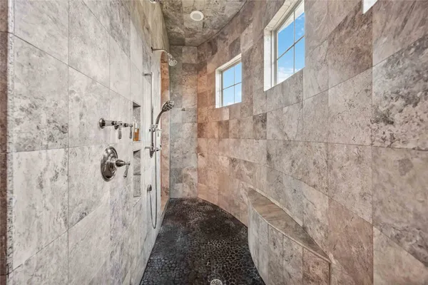 a spacious bathroom with a toilet sink and mirror