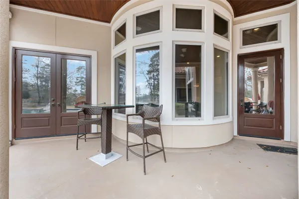 a view of swimming pool with lawn chairs and dinning table