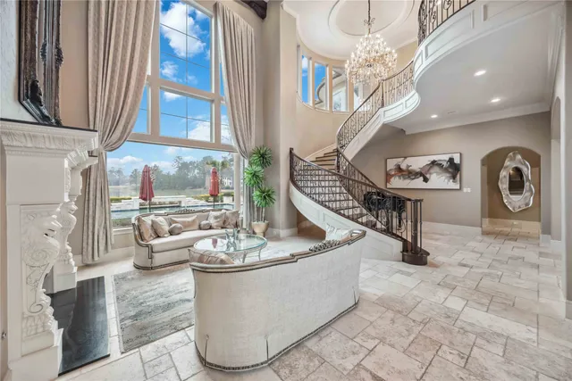 a view of a dining room with furniture and a chandelier