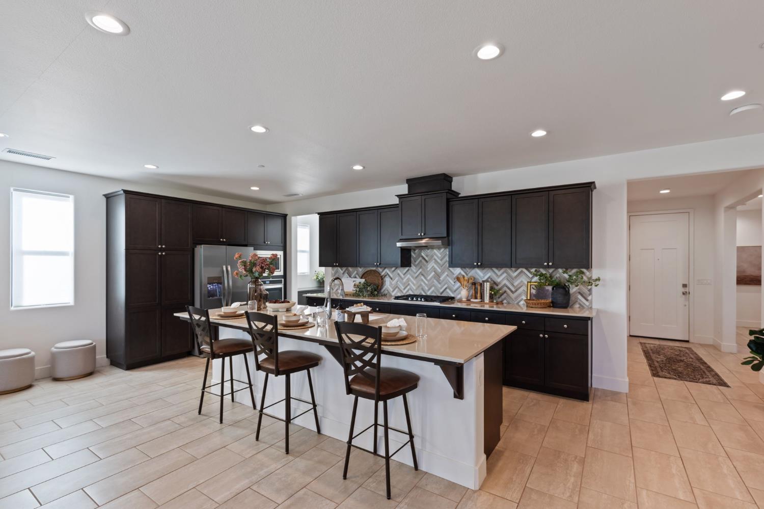 1022 Moonrise Way Madera, CA 93636 - Photo 12 of 52 a kitchen with stainless steel appliances kitchen island granite countertop a sink and cabinets