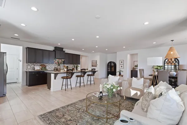 a living room with lots of furniture and kitchen view