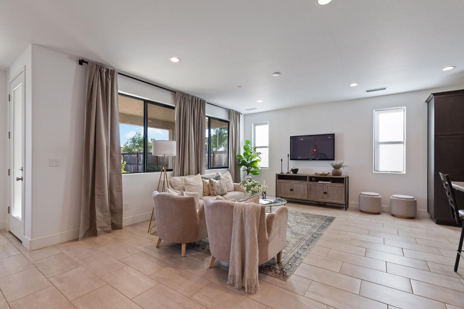 1022 Moonrise Way Madera, CA 93636 - Photo 16 of 52 a living room with furniture a flat screen tv and a large window