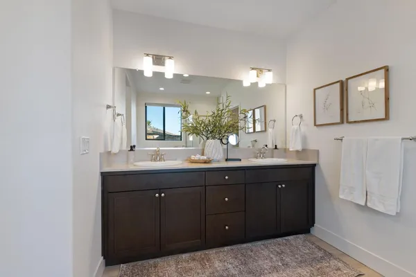 a bathroom with a double vanity sink and a mirror