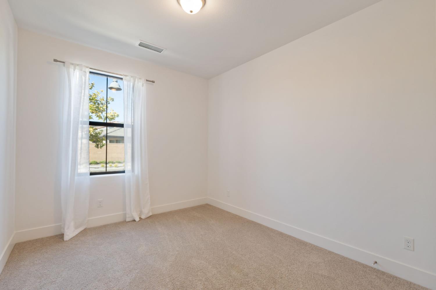 1022 Moonrise Way Madera, CA 93636 - Photo 26 of 52 an empty room with a window