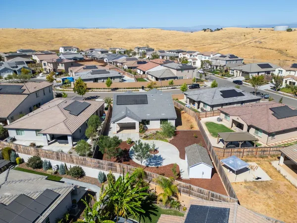 an aerial view of a house with a yard