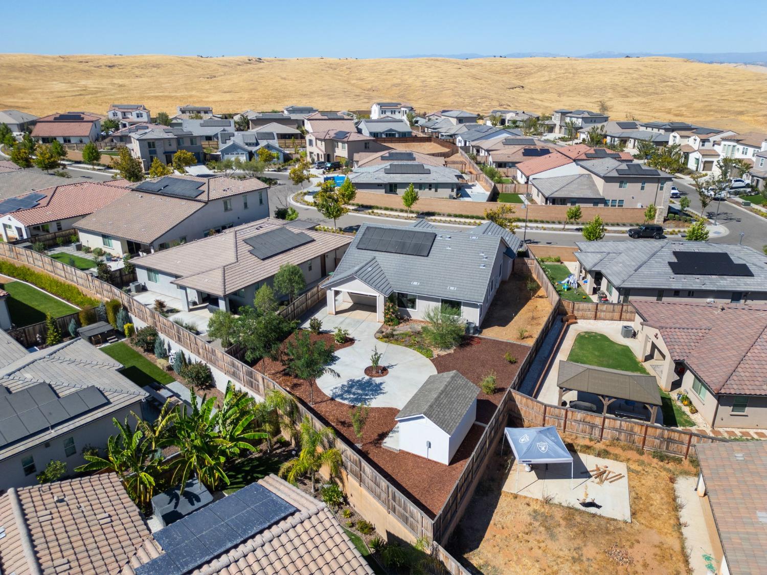 1022 Moonrise Way Madera, CA 93636 - Photo 49 of 52 an aerial view of a city with lots of residential buildings and ocean view in back