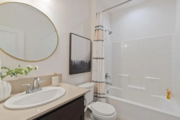 a bathroom with a sink a toilet and a mirror