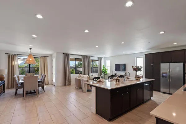 a kitchen with a sink counter top space and living room