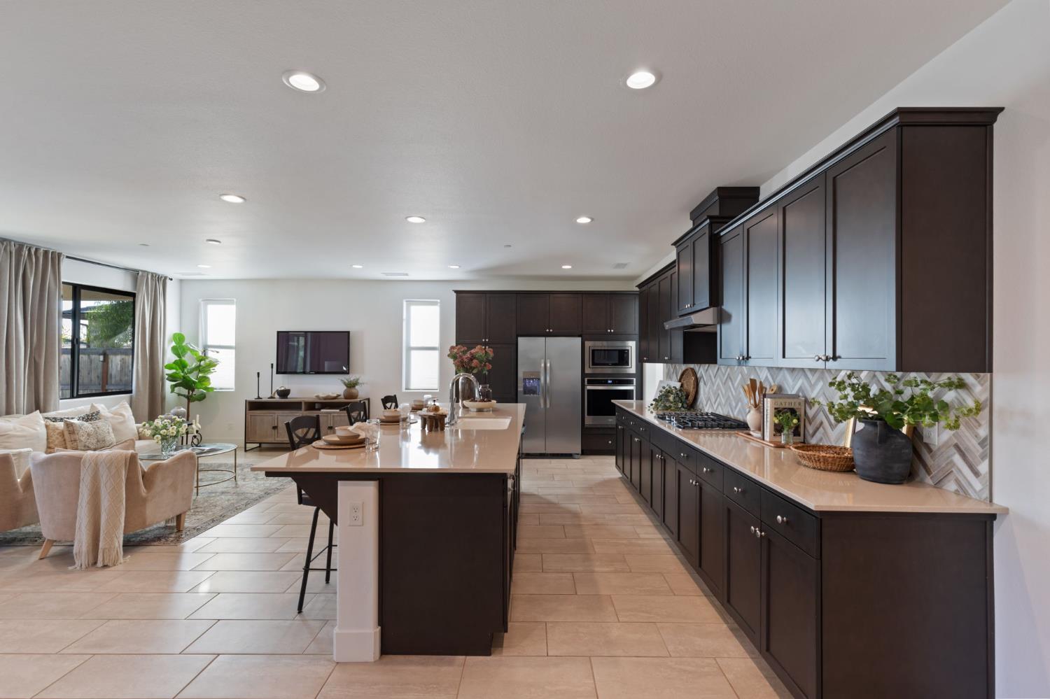 1022 Moonrise Way Madera, CA 93636 - Photo 10 of 52 a large kitchen with a large counter top furniture and stainless steel appliances