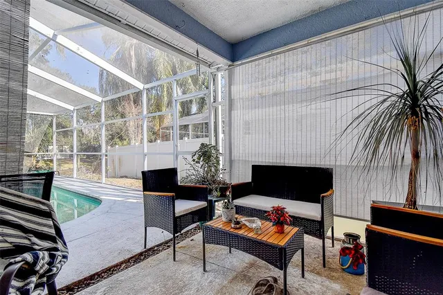 a living room with furniture a fireplace and a floor to ceiling window