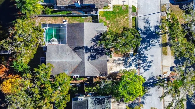 an aerial view of a house with swimming pool and garden