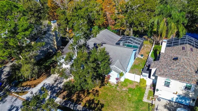 an aerial view of a house with a yard and swimming pool