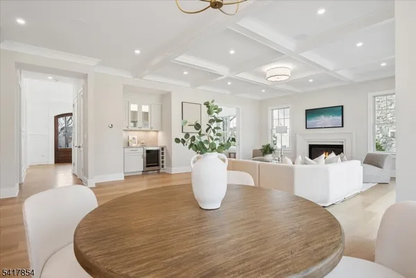 a room with stainless steel appliances kitchen island granite countertop furniture and a large window