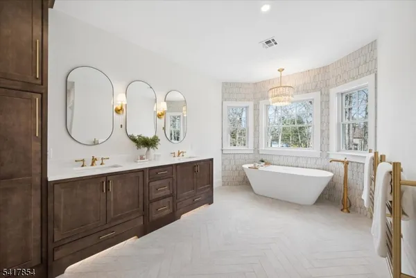 a white bath tub sitting in a bathroom next to a window