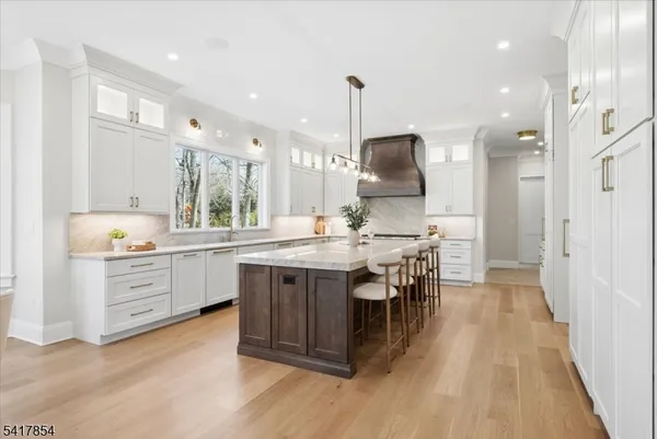 a kitchen with stainless steel appliances granite countertop a stove and a sink