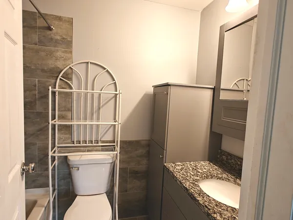 a bathroom with a toilet and a shower