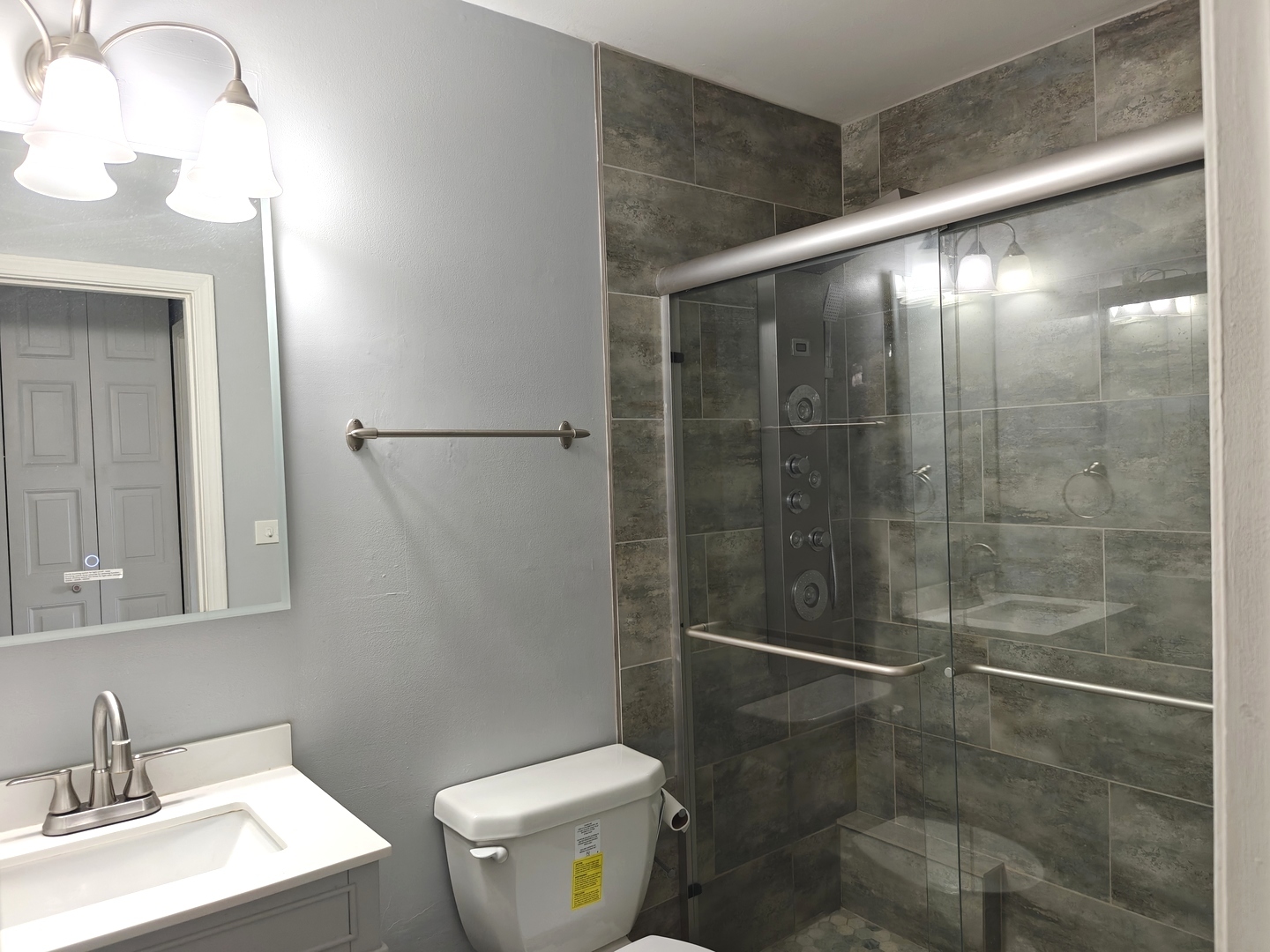 4721 St Joseph Creek Road, Unit 5F Lisle, IL 60532 - Photo 12 of 19 a bathroom with a shower a toilet and a sink