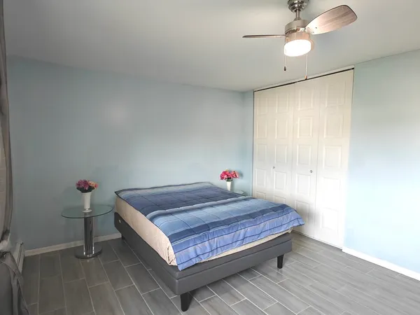 a bed sitting in a room next to a window