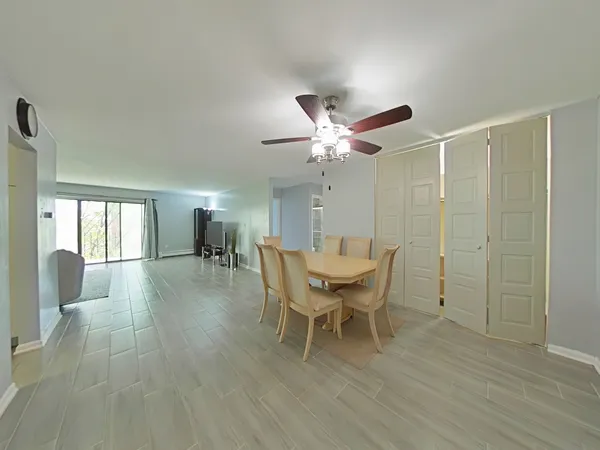 a dining room with furniture a chandelier and wooden floor